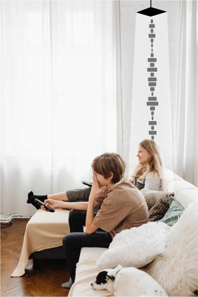 Directional speakers for home positioned above individual sat on the sofa